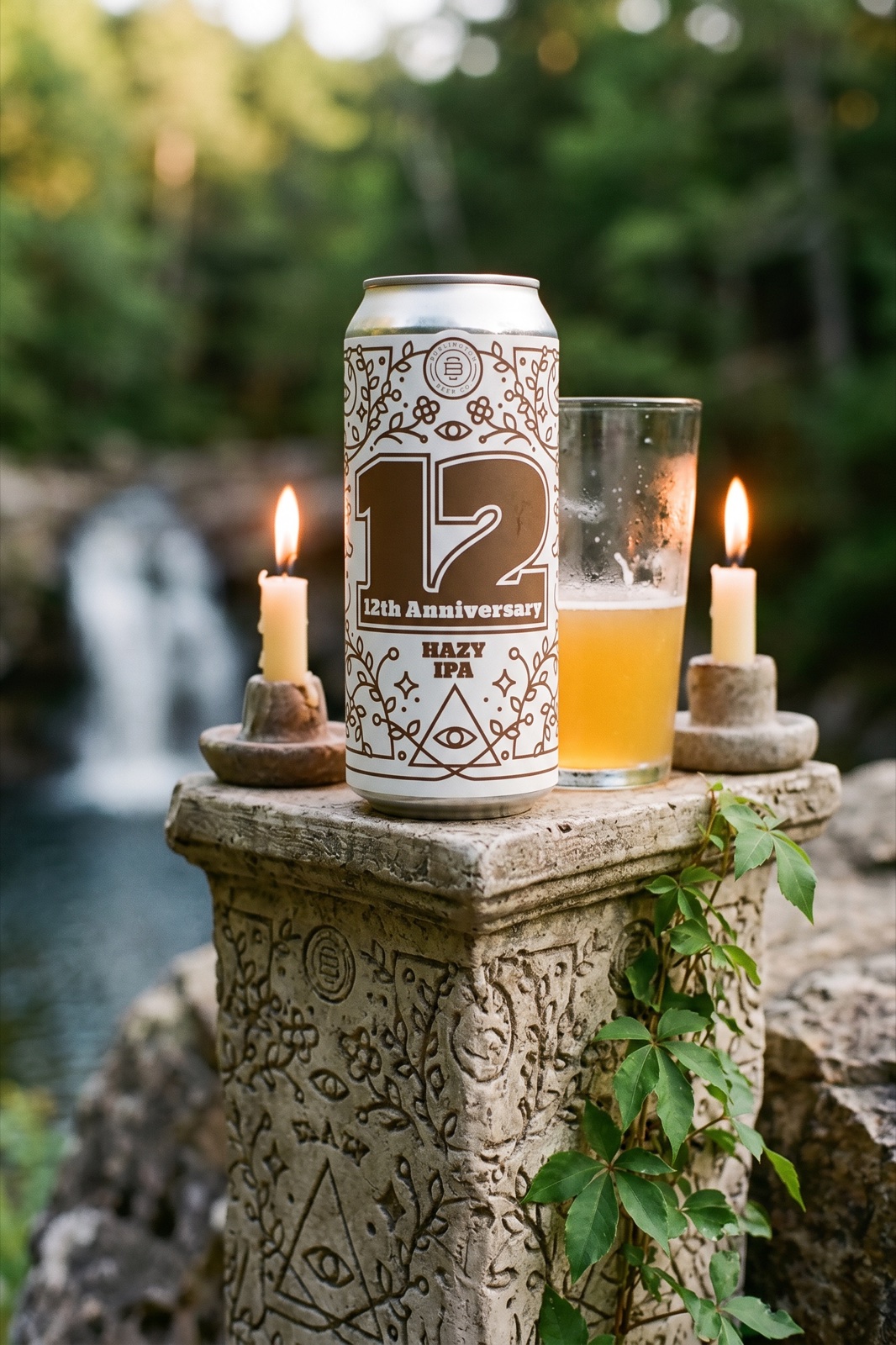 Burlington Beer Co. 12th Anniversary Hazy IPA on stone pillar with candles and waterfall
