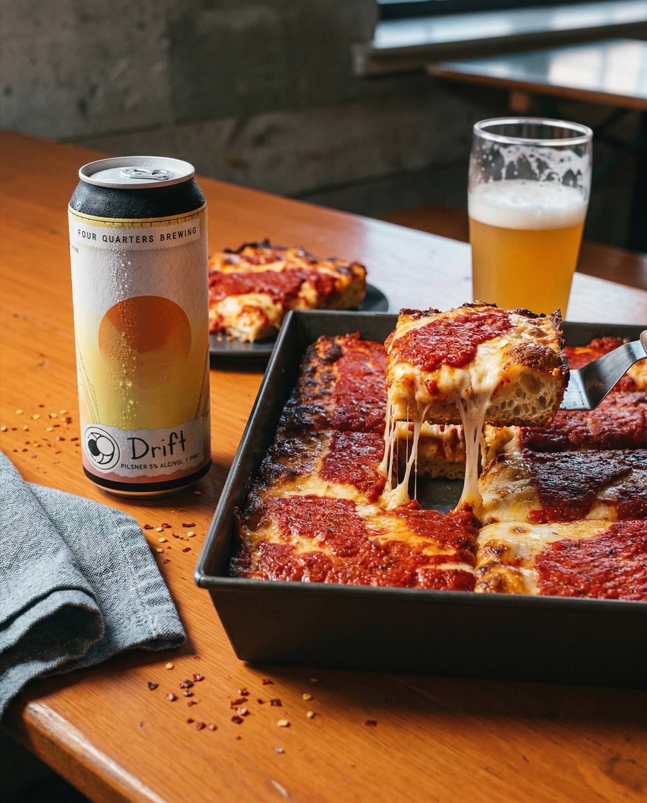Four Quarters Brewing Drift pilsner with Detroit-style pizza