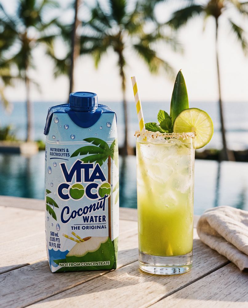 Vita Coco coconut water pineapple lime cooler poolside with palm trees
